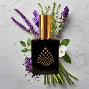 Perfume bottle with gold cap and black base against lavender flowers and green leaves. Perfume bottle with gold cap and black base against lavender flowers and green leaves.