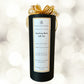 Black cylindrical container with gold bow labeled 'Soothing Bath Salt Set' on a white background.