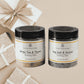 Two jars of 'White Tea & Thyme' and 'Sea Salt & Orchid' soaking salts with a decorative bow in the background.