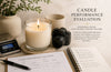 Candle on a table with a camera, digital scale, and evaluation form.