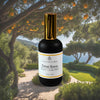 Luxury home fragrance–Citrus Grove mist is infused with lemongrass, lemon, and green leaves in a black bottle with gold cap.