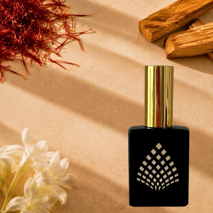 A black perfume bottle surrounded by saffron, white jasmine, and cedar pieces.