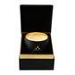 A black and gold Couture Home & Body candle inside a matching black and gold box, showcasing a luxurious and elegant design.