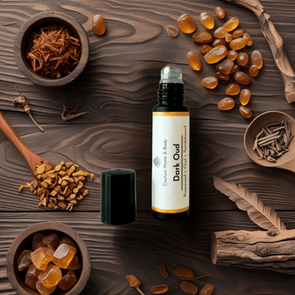 Bottle of Dark Oud perfume on a wooden surface with oudh ingredients.