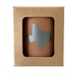 Dusty Rose candle jar with Texas shape cutout in a brown kraft box.