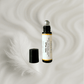 Roll-on perfume bottle labeled 'Milk Musk' on a soft, white background.