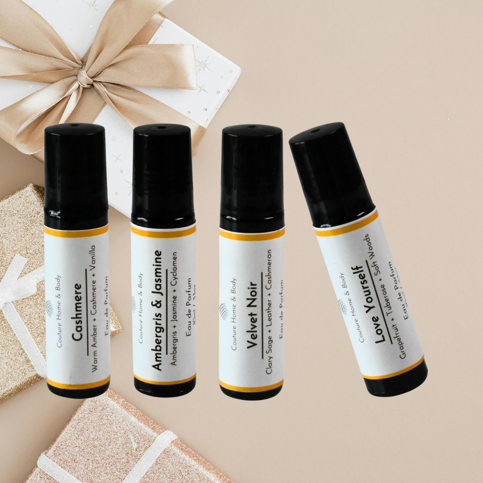 Four small bottles with black and white labels on a beige background.