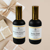 Two bottles of Couture Home & Body room and linen mist with decorative items on a beige background.