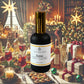 A sleek black bottle with a gold cap labeled "Soirée Room + Linen Mist" from Couture Home & Body set against a festive holiday scene with bottles of wine and cocktails surrounded by ornaments, wrapped presents, and treats, evoking the warm, inviting ambiance of the Soirée candle.