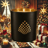 Soirée candle infused with candied fruits, chestnuts, and spices in a black jar with gold interior.