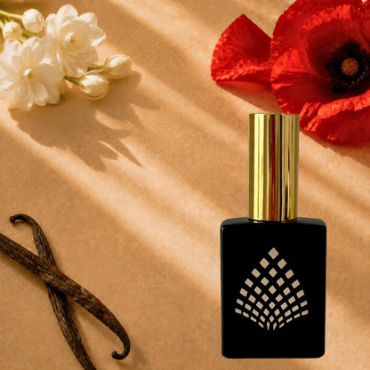 A black perfume bottle on a warm tan surface with red poppy, jasmine, and vanilla beans.