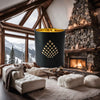 Luxury home fragrance-Winter Chalet candle infused with cedarwood, amber, and spices in a matte black jar with gold interior.